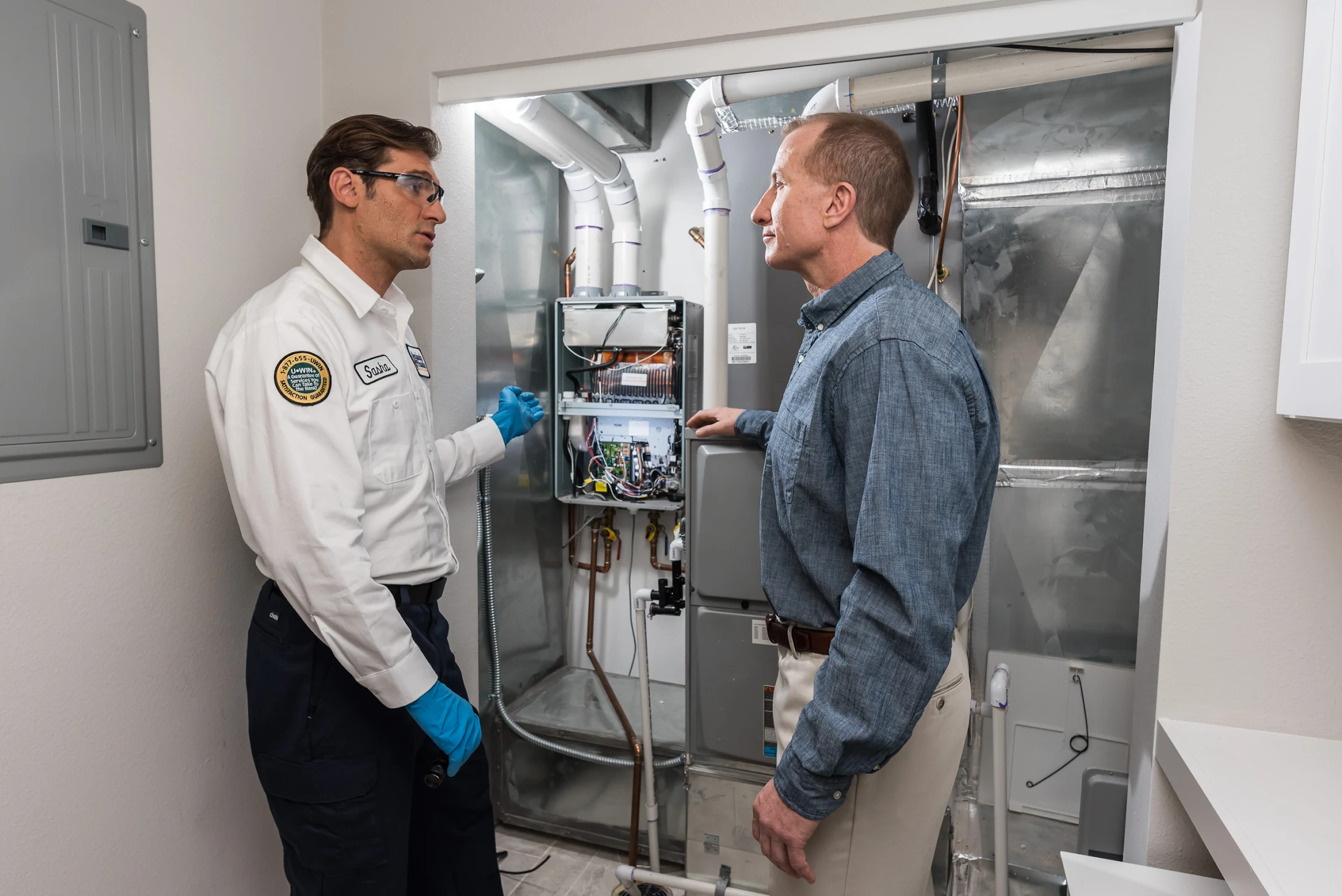 Technician explaining HVAC system to a homeowner.